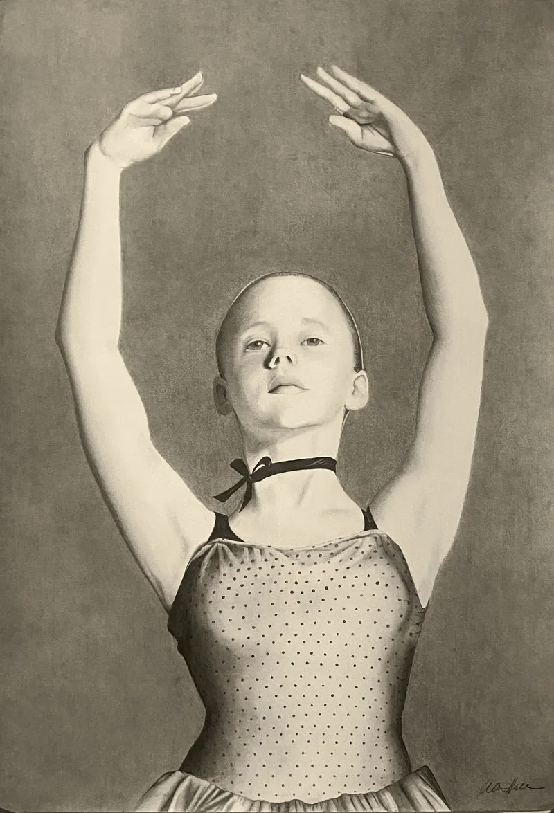 Young ballerina with arms raised
